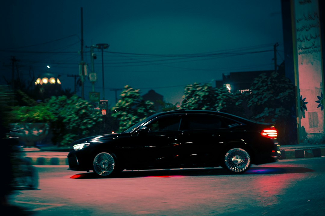 Luxury black car at night representing premium car rental in Islamabad